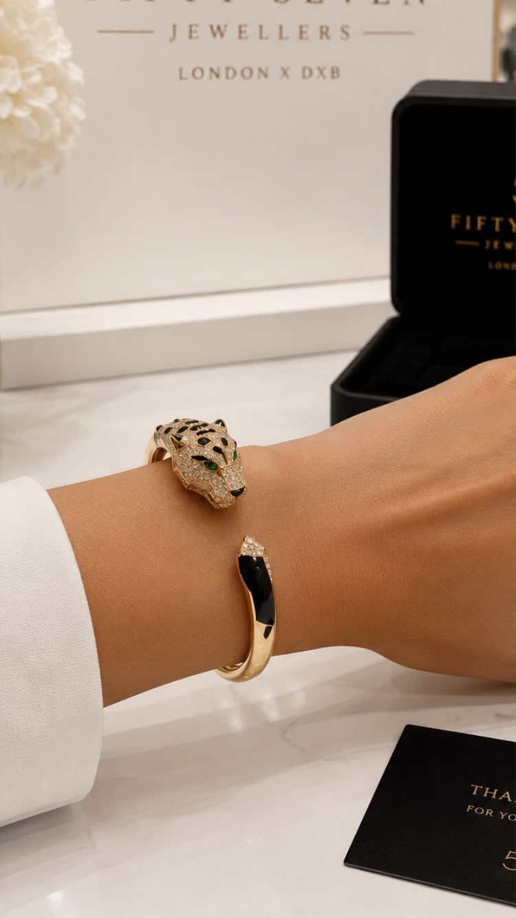 Diamond Pavé Panther Bangle worn on wrist with 57 Jewellers box